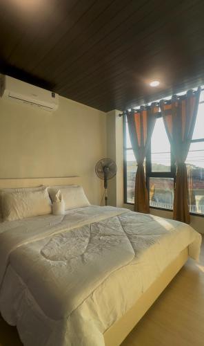 a bedroom with a large bed and a window at AH Homes Kulai in Kulai