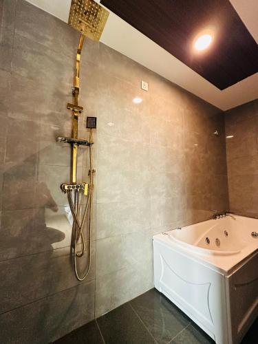 a bathroom with a shower and a bath tub at AH Homes Kulai in Kulai
