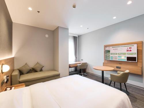 a hotel room with a bed and a couch at SUPER HOTEL HANOI - Grand Opening in 17 March 2026 in Hanoi