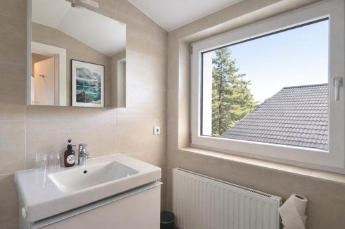 a bathroom with a sink and a window at Seelos - Alpine Easy Stay - Bed & Breakfast in Mieming