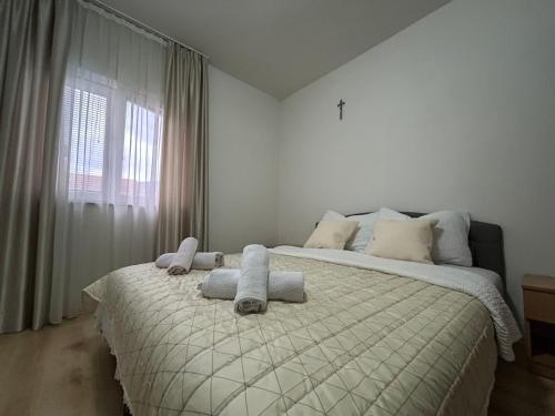 a bedroom with a bed with towels on it at Maća i Ante Pavlović in Međugorje