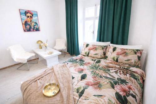 a living room with a bed and green curtains at Old Town Studio - Stay Olomouc CZ in Olomouc