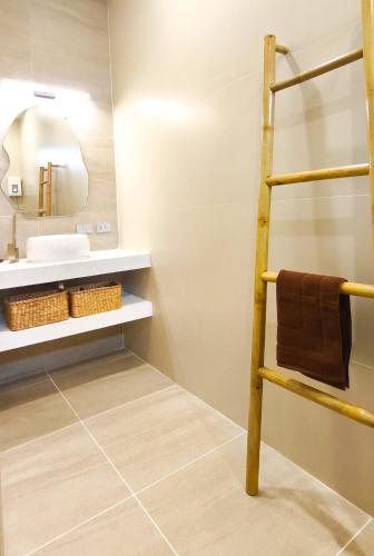 a bathroom with a towel rack and a sink at Samma Villas - Ruby Villa - 2 BDR & private pool in Ko Phangan