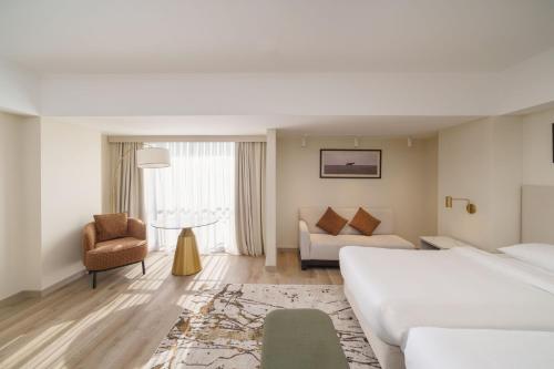 a hotel room with a bed and a couch at Hyatt Regency Bishkek in Bishkek
