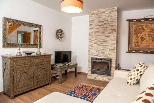 a living room with a fireplace and a mirror at Moinhos do Pisão in Povoa Dao