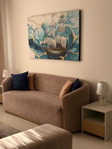 a living room with a couch and a painting on the wall at Beach Front Escape in Wattala