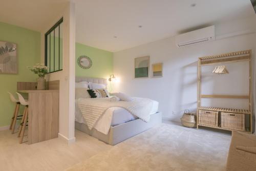 a bedroom with a bed and a desk in it at Le Nid Vert - air conditioning - ground floor in Bourg-en-Bresse