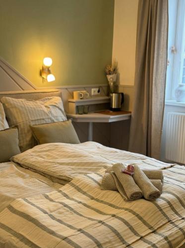 a bed with two slippers on top of it at Grazerhof in Graz
