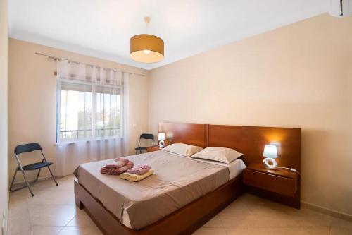 a bedroom with a bed with two towels on it at Almancil Park Apartment in Almancil
