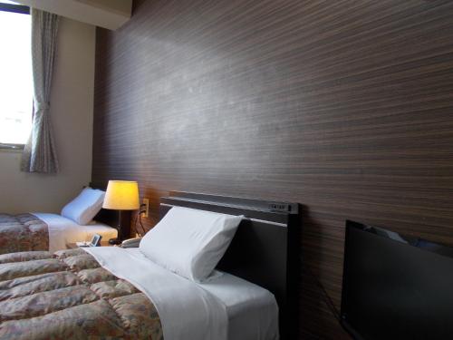 Postel nebo postele na pokoji v ubytování Hotel Matsuyama Hills