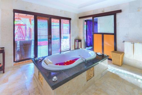 a large bathroom with a large bath tub at Lavender Private Villa Kuta Bali in Kuta