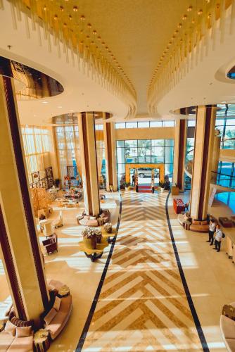 a lobby of a building with many windows at Muong Thanh Luxury Ca Mau Hotel in Cà Mau