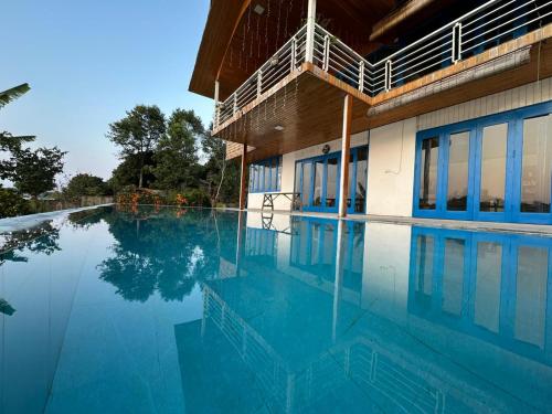a swimming pool in front of a building at Maisonson Resort in Dương Kê