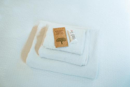 a stack of towels with a book on them at Cà del Lasco - Free parking apartments 5 min from the station in Bellano