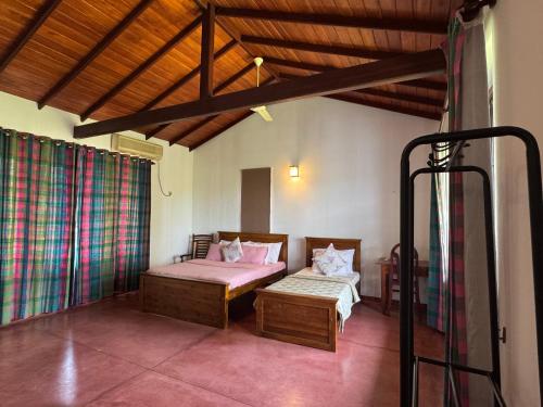 a bedroom with a bed and a bench in a room at The fields Malabe in Malabe