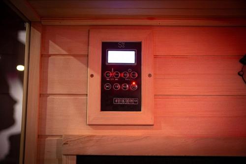 an electronic device on the side of a house at L'Eclipse - Exceptional SPA Suite, sauna and hammam in Douai