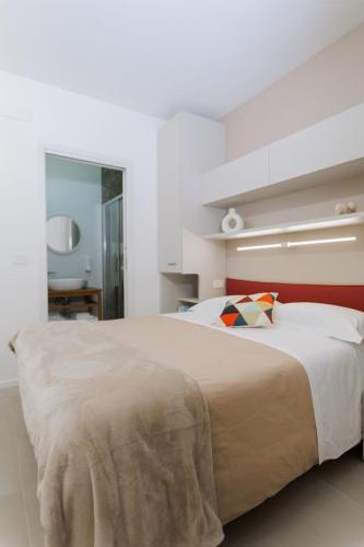 a bedroom with a large bed with a red headboard at ZENIT Appartamenti & SPA in Terni