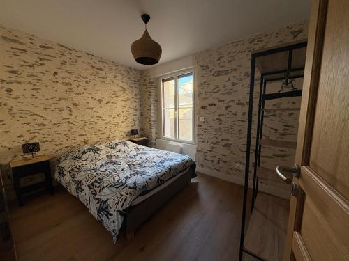 a bedroom with a bed and a window at Maison de charme centre Pornic in Pornic