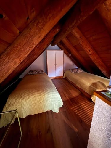 a bedroom with two beds in a attic at Romantic Ticino Rustici in Gordola