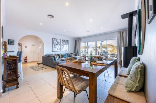 a living room with a table and a couch at Burgau Sea View, Beach & Pool Villa in Budens