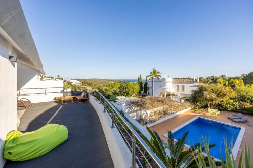 a balcony of a house with a swimming pool at Burgau Sea View, Beach & Pool Villa in Budens