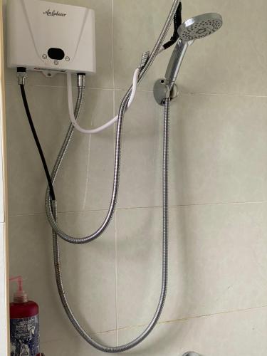 a shower with a shower head in a bathroom at Luxore Apartments Syokimau No E803 in Syokimau