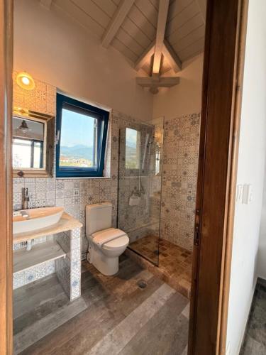 a bathroom with a toilet and a sink and a shower at Pantazi Beach House in Kotrónion