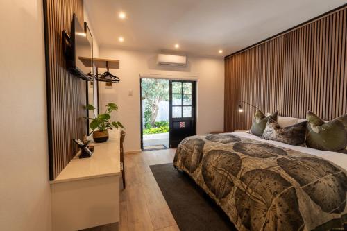 a bedroom with a large bed with a large wooden headboard at Shelanti Guesthouse in Ceres
