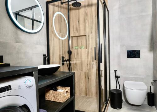 a bathroom with a sink and a washing machine at Central Suites Aegina 1 in Egina