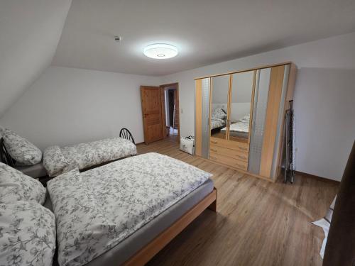 a bedroom with a bed and a sliding glass door at Haus Perla in Saarburg
