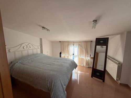 a bedroom with a bed and a dresser and a mirror at SEGEDA 3 APARTAMENTOS Turísticos in Calatayud