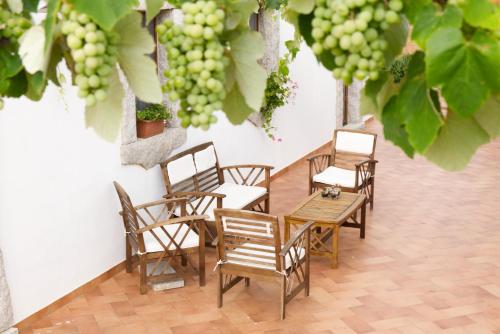 a group of chairs and a table and some grapes at Villamarina in Aglientu