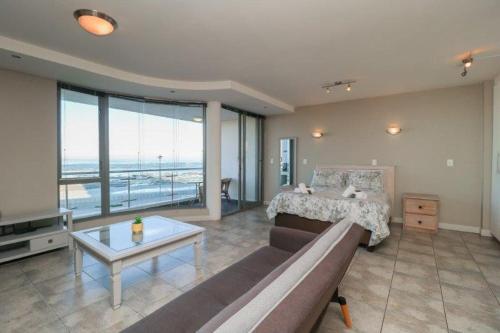 a living room with a couch and a bed at 302 Hibernian Towers Self Catering Accommodation in Strand