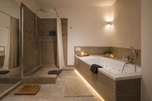 a bathroom with a bath tub and a shower at Kaiserhof in Karlsruhe