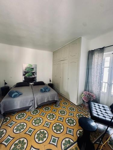 a bedroom with a bed and a large rug at Maison colette CORDOLIANI in Brando