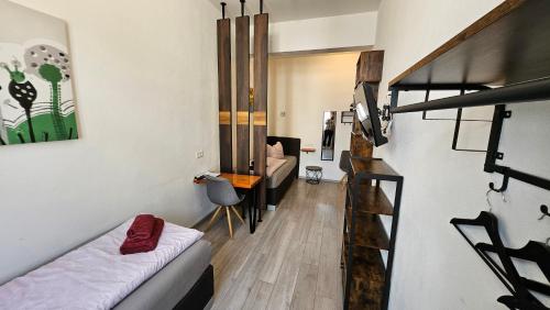 a small room with a loft bed and a living room at Zum Obstler - Gaststätte und Pension in Gera