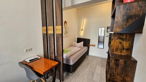 a small living room with a couch and a table at Zum Obstler - Gaststätte und Pension in Gera