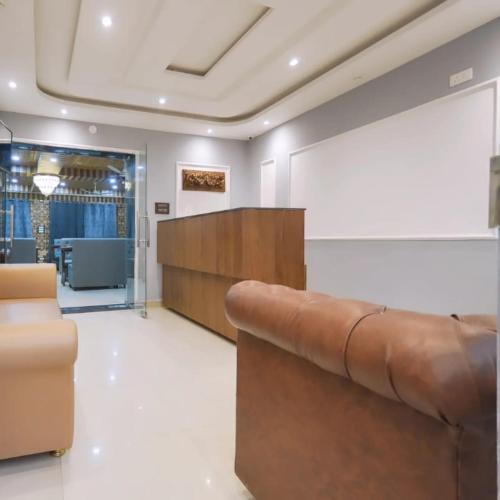 a waiting room with a couch and a table at Hotel Your Hive in Srinagar