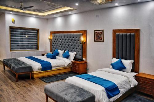 a hotel room with two beds and a couch at Kaldan Palace in Hundar