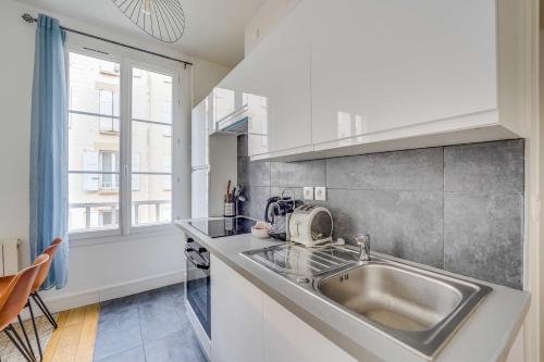 a kitchen with a sink and a microwave at Charming Apartment 2BR 4P - Saint-Cloud in Saint-Cloud