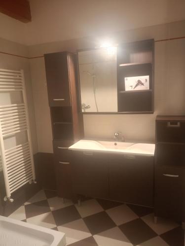 a bathroom with a sink and a mirror at Corte Don Bosco 4 in Monfalcone