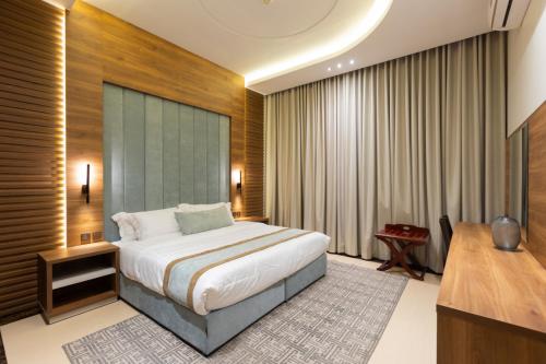 a hotel room with a bed and a television at Topaz Serviced Apartments in Riyadh