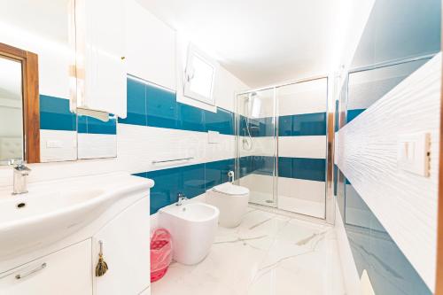 a bathroom with a sink and a toilet at Porto Cesareo - Appartamenti e camere in Porto Cesareo