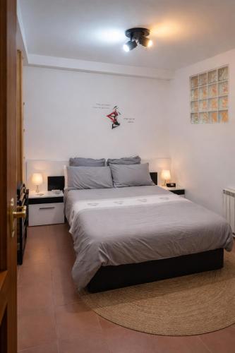 a bedroom with a large bed and two night stands at Winahost Coslada Av Lisboa in Coslada