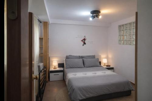 a bedroom with a bed and two night stands and two lamps at Winahost Coslada Av Lisboa in Coslada