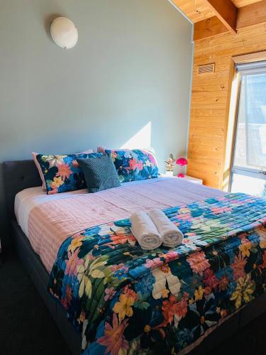 a bedroom with a bed with two towels on it at No 43 Guesthouse in Mount Beauty