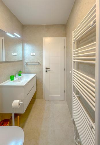 a bathroom with a white sink and a mirror at Apartment Maraska in Zadar