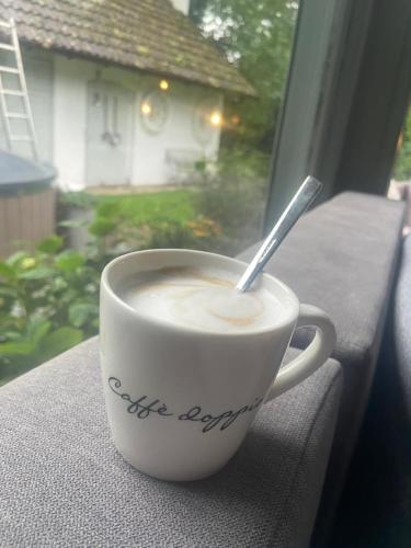 a cup of coffee sitting on a window sill at Ranczo in Smołdzięcino