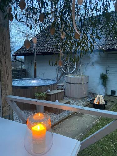 a candle sitting on a table in a backyard at Ranczo in Smołdzięcino