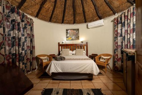 a bedroom with a bed in a room with curtains at Van Zylsvlei - A Karoo Guest Farm in Colesberg